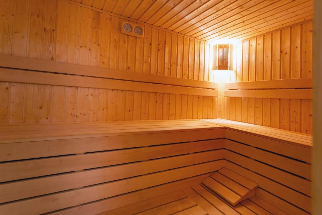 a wooden sauna with a light in it at Family Hotel Jemelly in Obzor