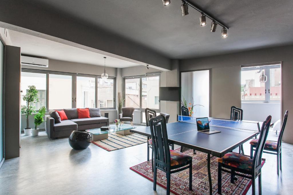salon ze stołem, krzesłami i kanapą w obiekcie Artists’ favorite Spacious Loft near Acropolis!! w Atenach