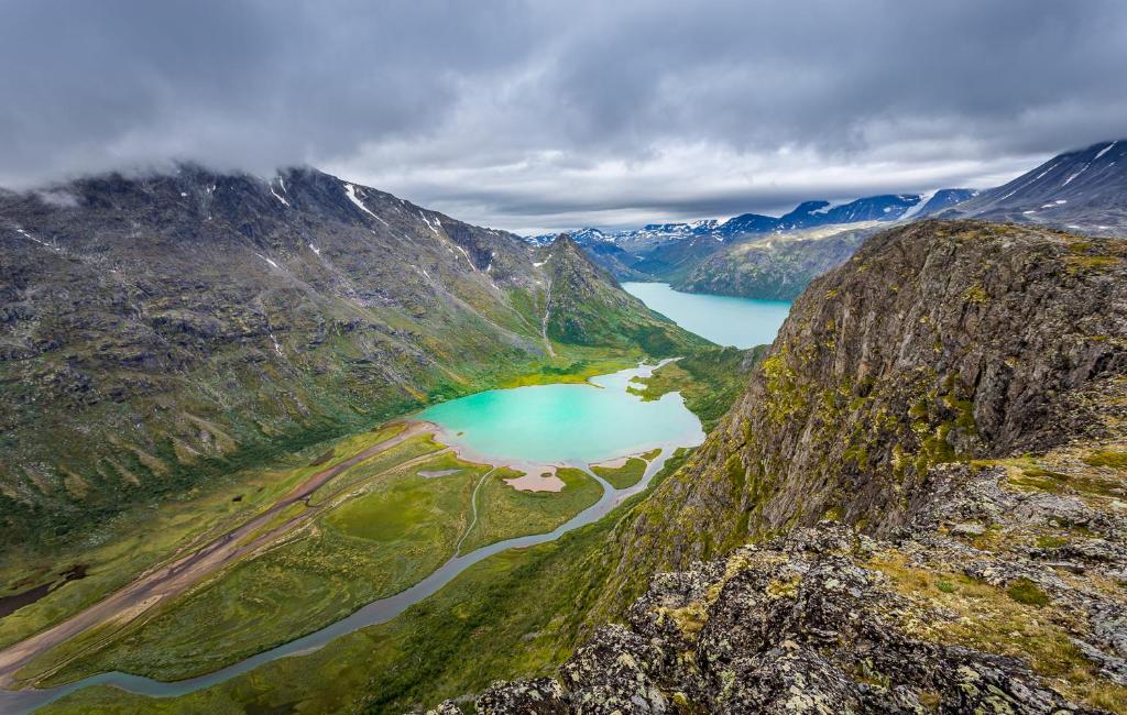 an aerial view of a mountain with a lake at Jotunheimen Husky Lodge in Randsverk