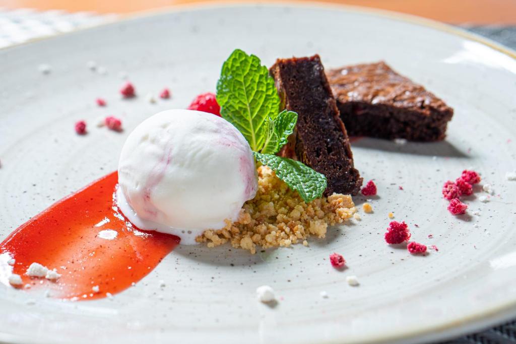 a white plate with a dessert with a scoop of ice cream at Monte Santo Resort in Carvoeiro