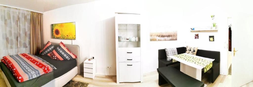 een slaapkamer met een bed, een stoel en een bureau bij Ferienwohnung Reni in Sankt Englmar