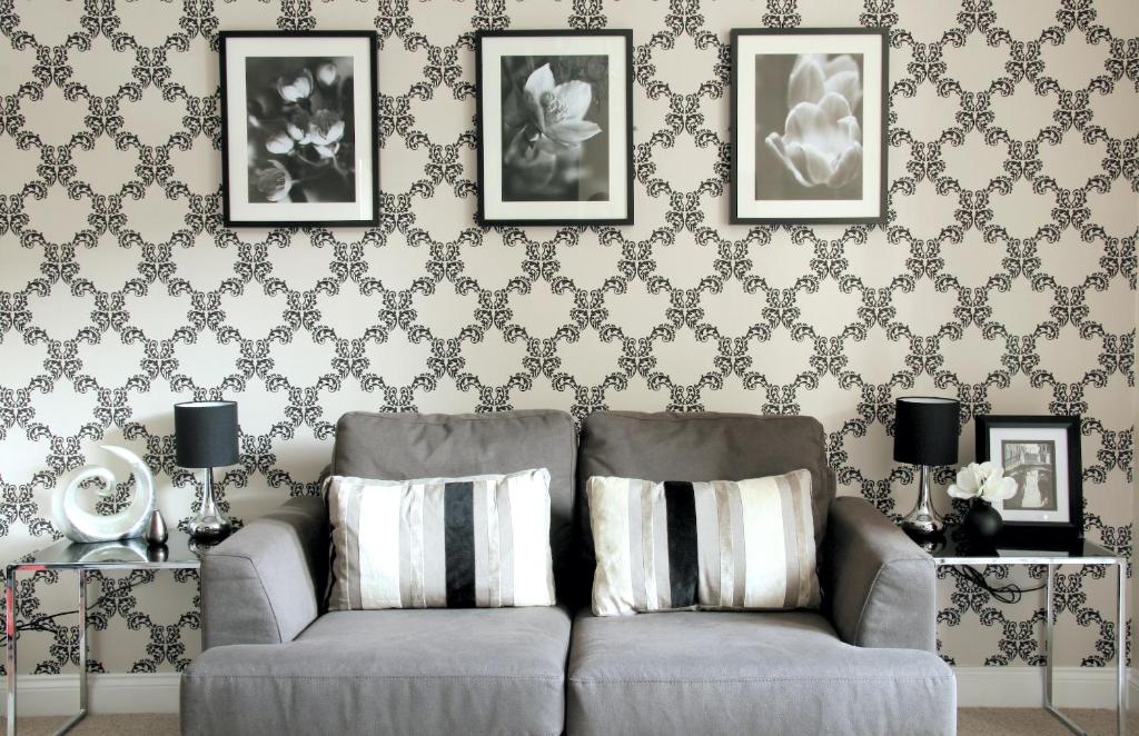 a living room with a couch and a wall with wallpaper at Harrogate Boutique Apartments - Self Contained Apartments in Harrogate
