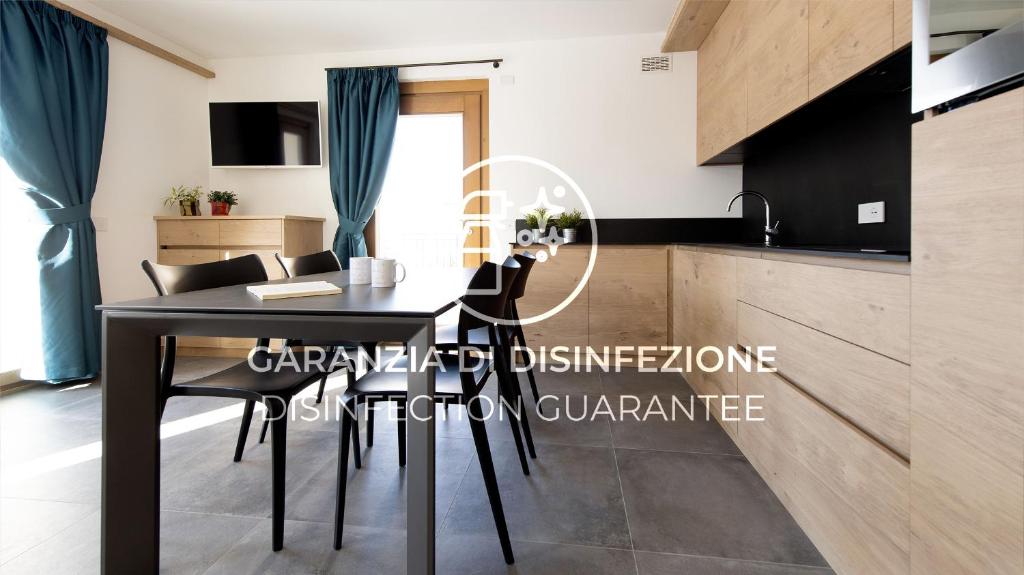 a dining room table and chairs in a kitchen at Italianway - San Pietro 8 in Valdisotto