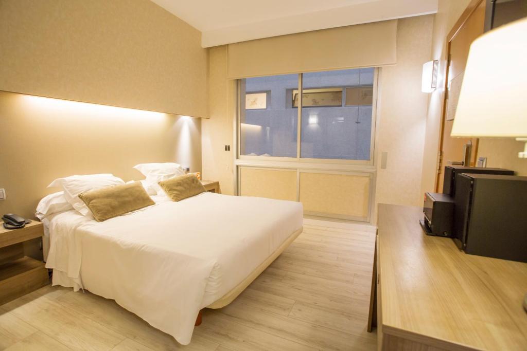 Postel nebo postele na pokoji v ubytování Aparthotel Silver