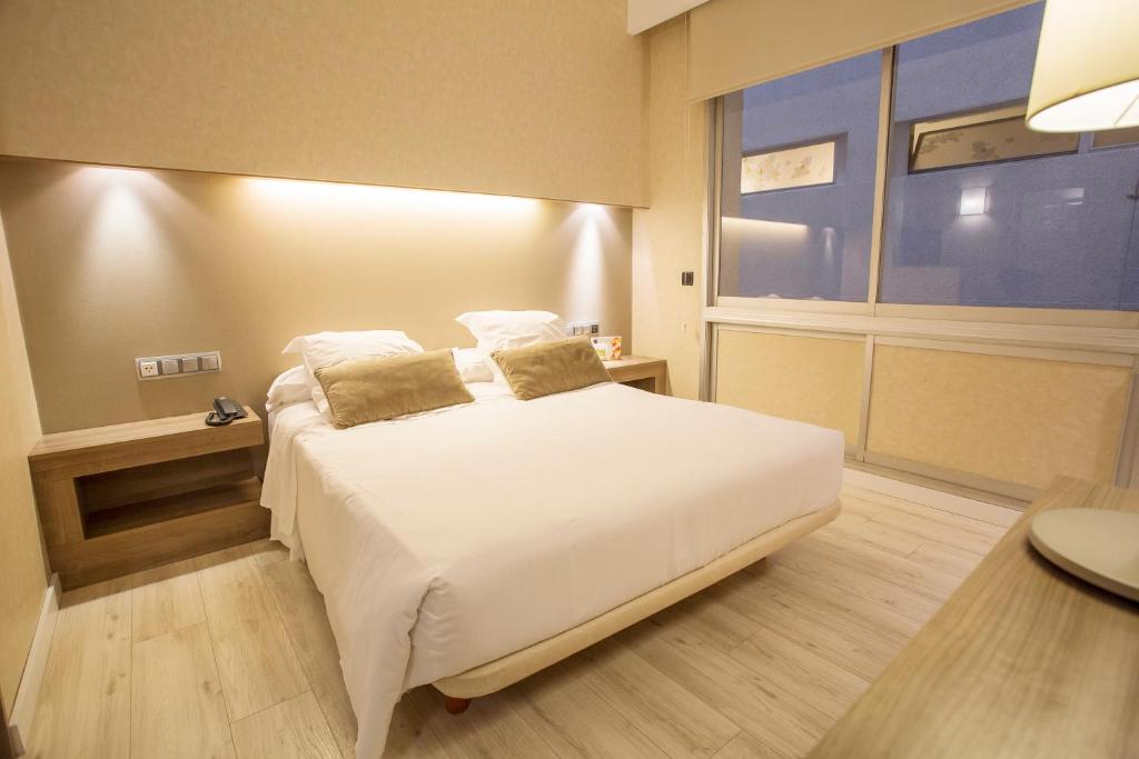 Postel nebo postele na pokoji v ubytování Aparthotel Silver