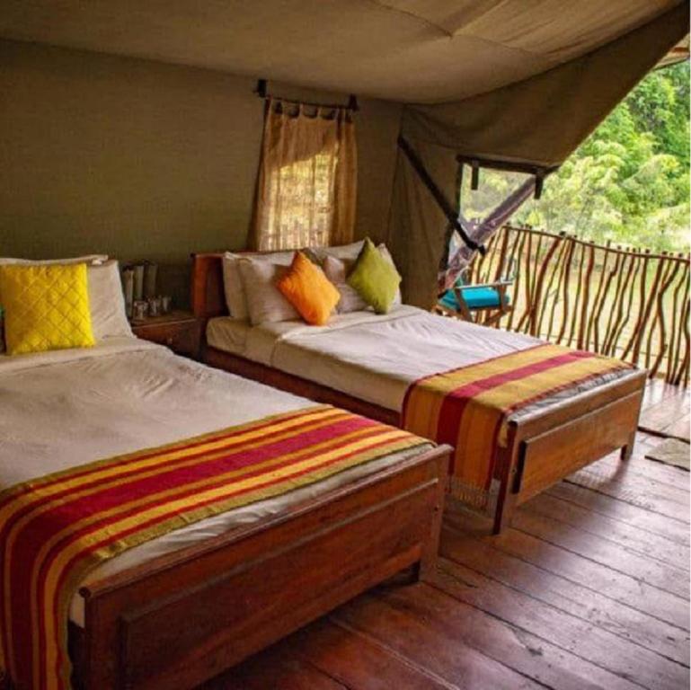 a bedroom with two beds in a tent at Camp Leopard - Yala Safari Glamping in Yala