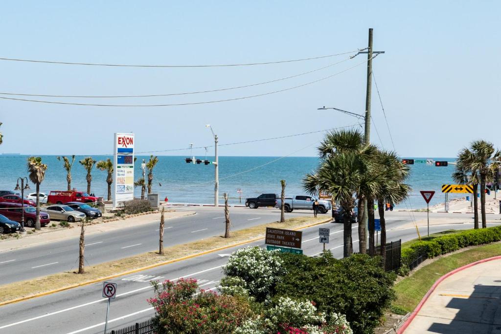 a view of a road with the ocean in the background at Casa Del Mar Beachfront in Galveston