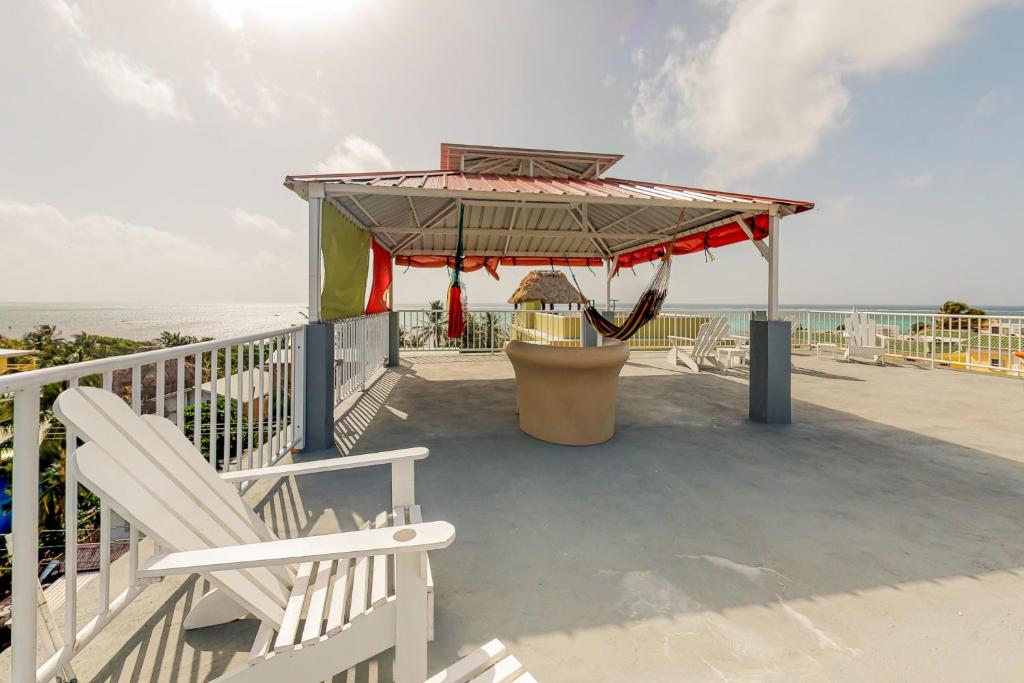 a deck with a bench and a playground with the ocean at Laguna Suites in San Pedro