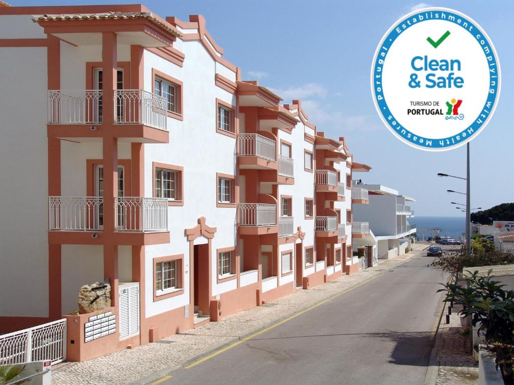 a building with a sign that says clean and safe at Apartamentos Monte da Vinha I in Albufeira