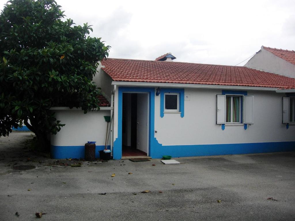 a white and blue house with a blue door at 3 bedrooms house with shared pool enclosed garden and wifi at Pataias in Pataias
