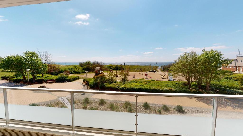 a balcony with a view of a park at Südkap F-03 in Pelzerhaken