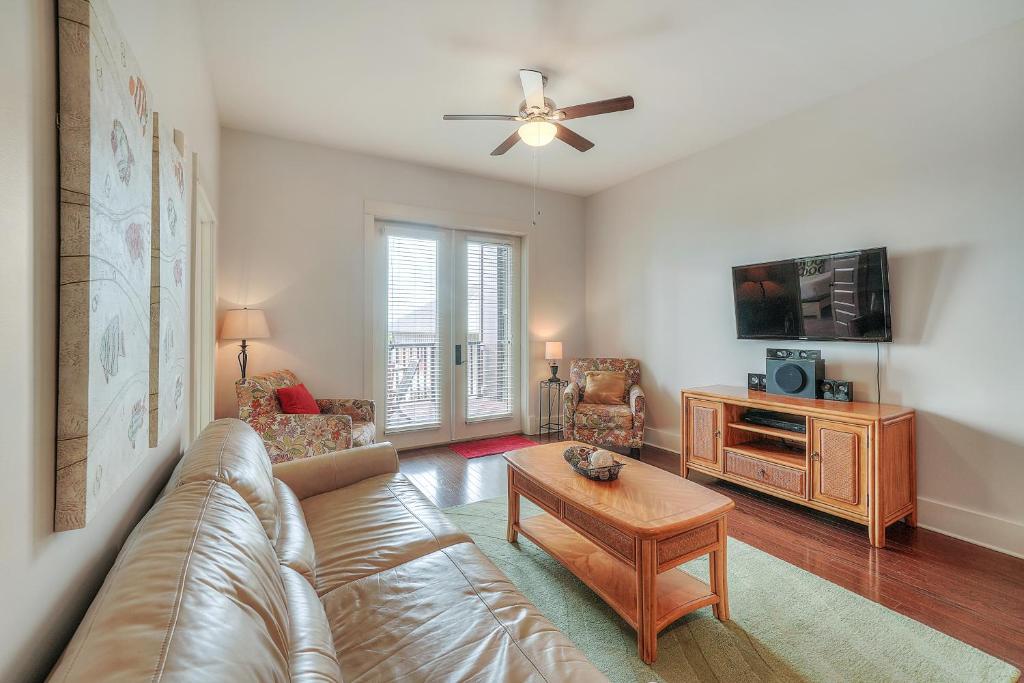 a living room with a couch and a tv at Redfish Village Condos in Santa Rosa Beach