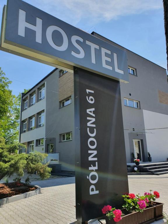 a sign for a hotel in front of a building at Hostel Północna 61 in Sosnowiec