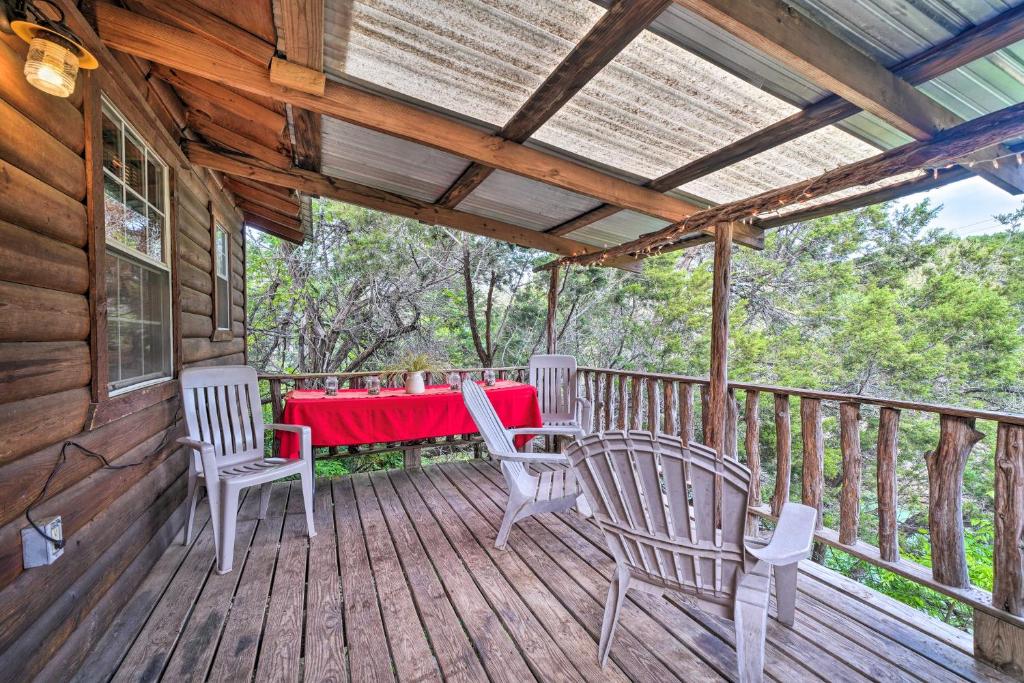 a wooden deck with a table and chairs on it at Cozy Davis Cabin with Deck - Nestled by Honey Creek! in Davis