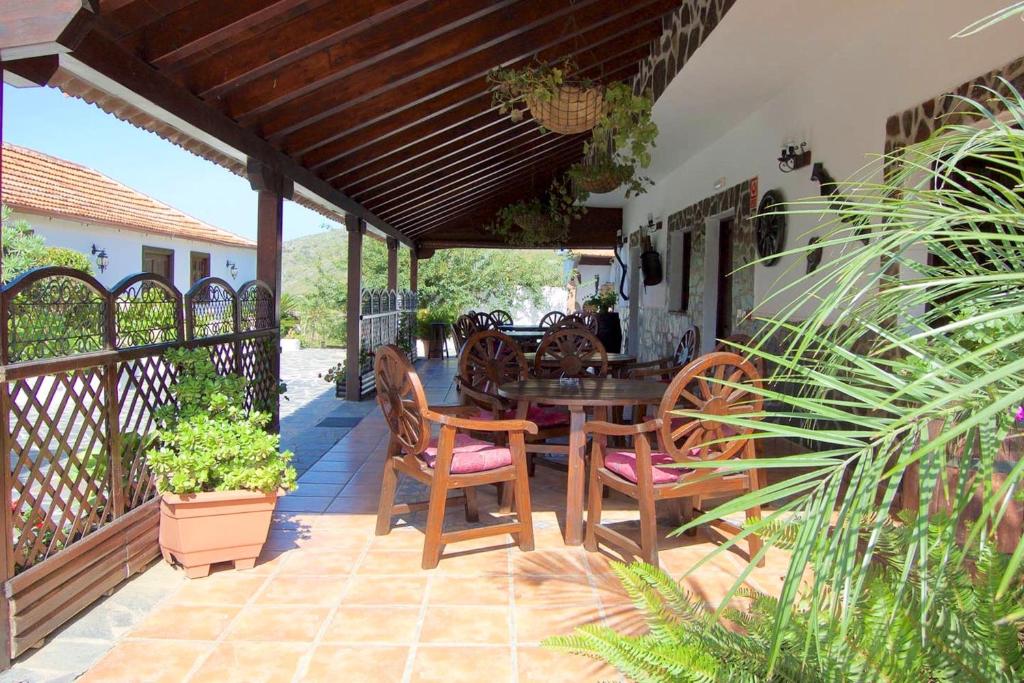 a patio with a wooden table and chairs at One bedroom appartement with furnished terrace and wifi at Los Silos 5 km away from the beach in Los Silos
