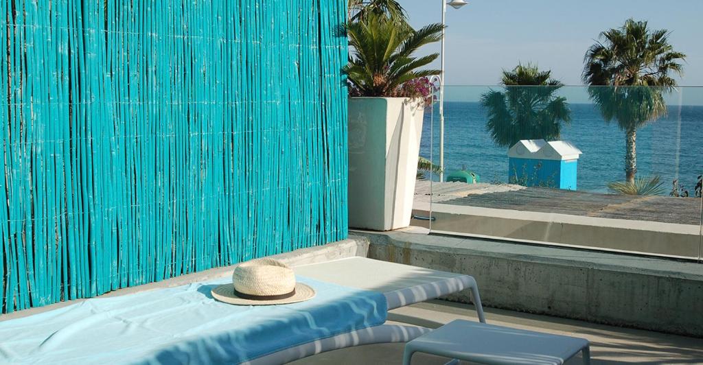 a hat sitting on a table next to a pool at H Boutique Peña Parda in La Herradura