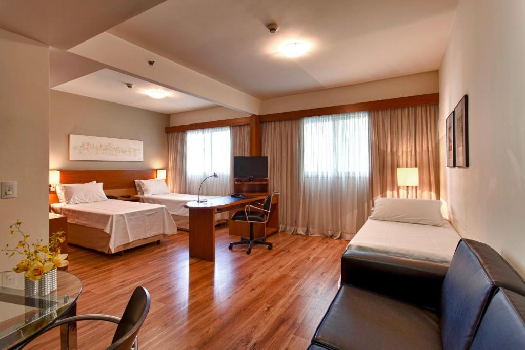 a hotel room with a bed and a desk at Tulip Inn São Paulo Paulista (antigo Tulip Inn Paulista Convention) in São Paulo