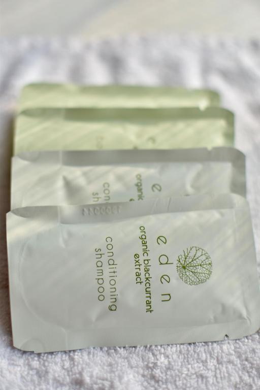 two packages of soap sitting on a bed at Witchingham B&B in Holyhead