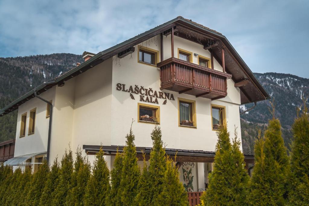 a building with a balcony on the side of it at Kala B&B in Kranjska Gora