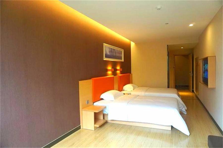 a bedroom with a large white bed in a room at 7Days Premium Nanchong Silk Road Branch in Nanchong