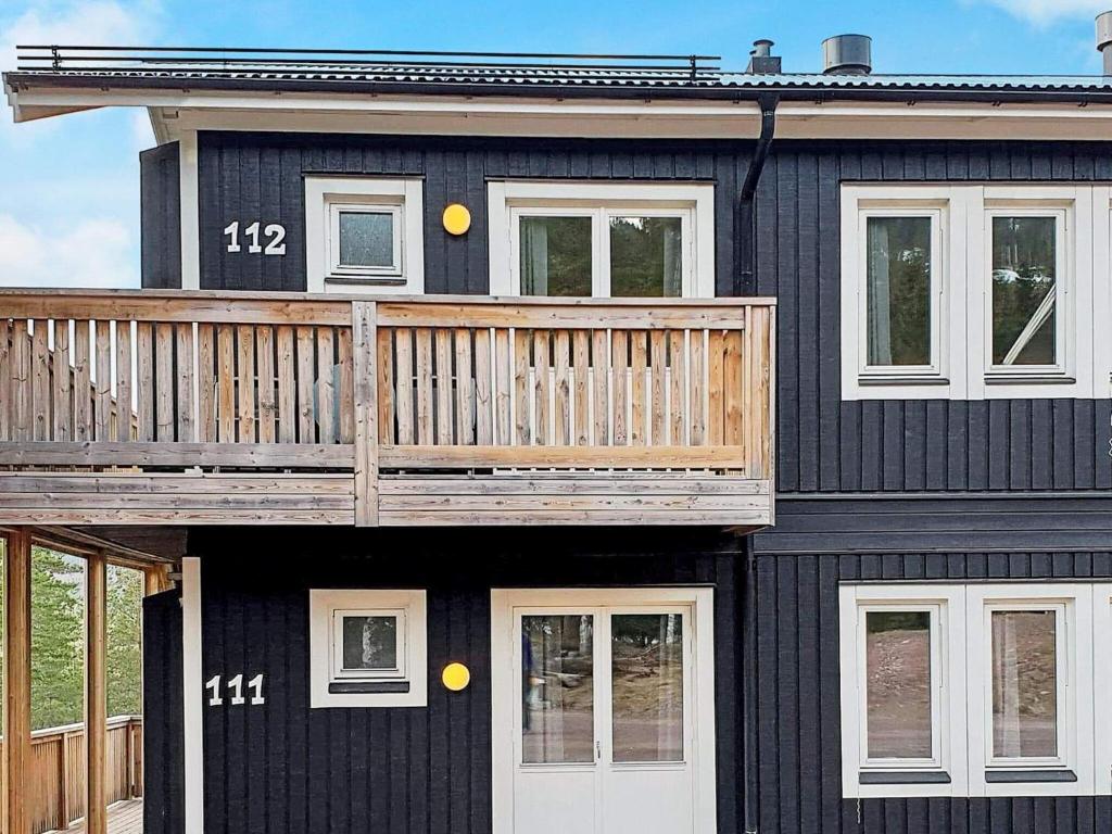 a black house with a deck on top of it at 10 person holiday home in S LEN in Sälen