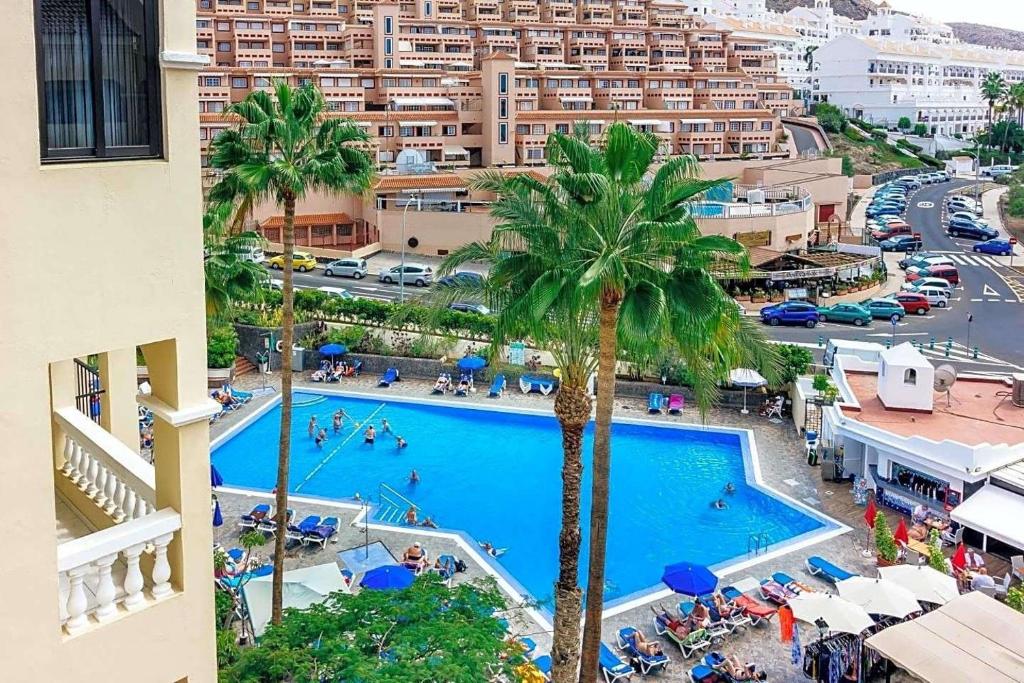 an overhead view of a swimming pool in a city at Peaceful & Bright Loft, HEATED POOL, NETFLIX, FREE WIFI & PARKING, TENNIS in Los Cristianos