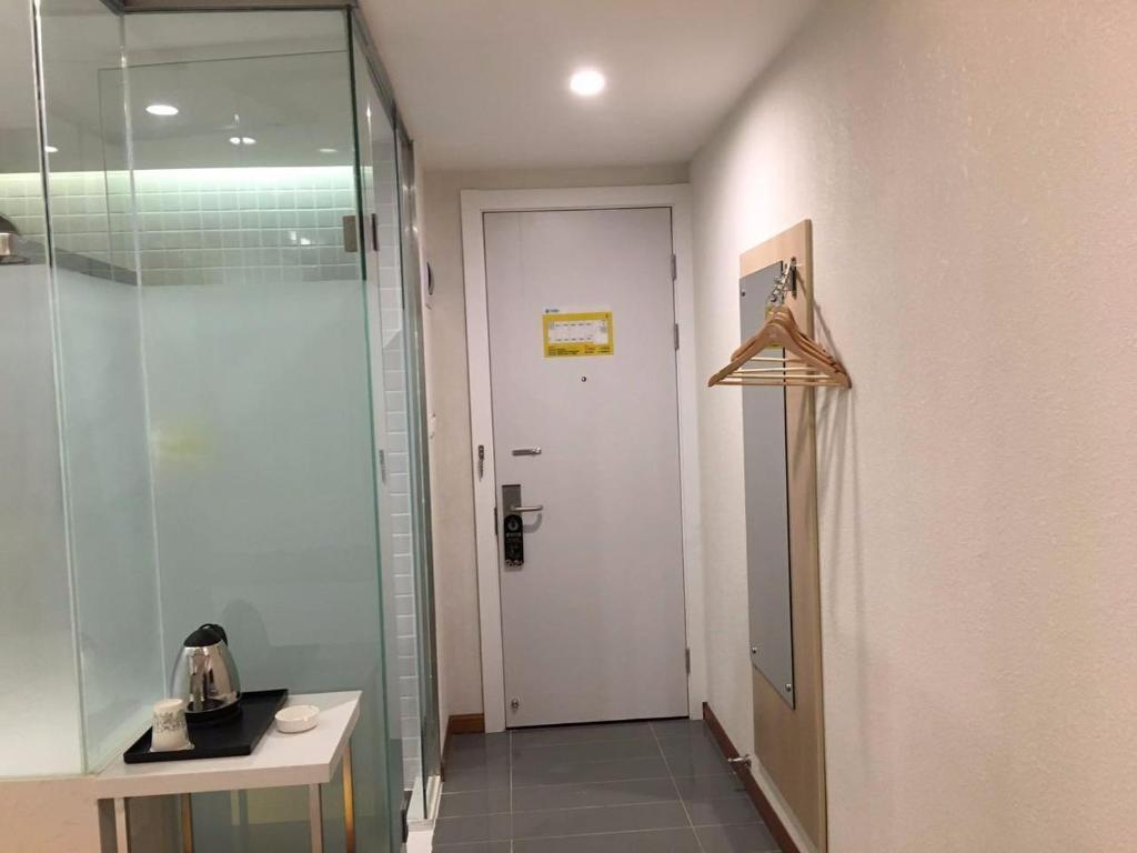 a bathroom with a shower and a glass door at 7 Days Hotel Taixing Wenchang Road Branch in Taizhou