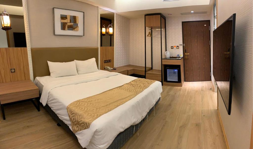 Postel nebo postele na pokoji v ubytování Wang Fu Hotel