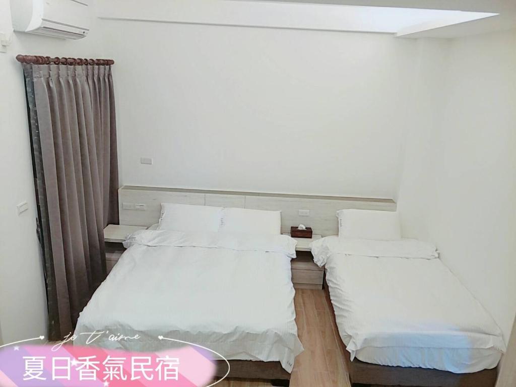 Postel nebo postele na pokoji v ubytování Penghu Summer Aroma Homestay