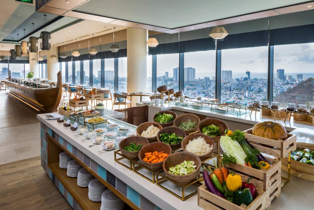 a buffet at a hotel with vegetables in baskets at Fusion Suites Vung Tau in Vung Tau