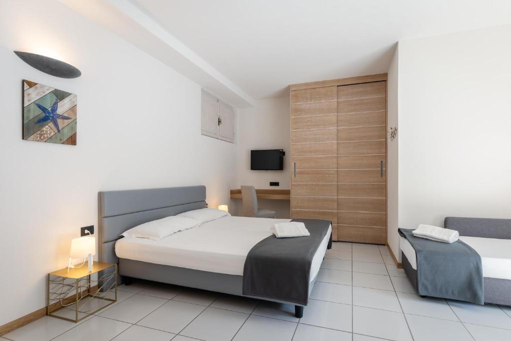 Postel nebo postele na pokoji v ubytování Hotel Delfino