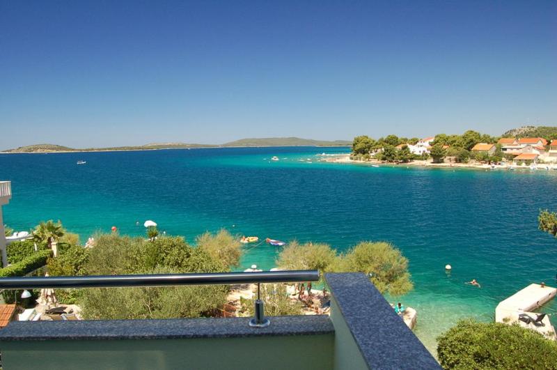 a view of a body of water with a beach at Apartman Relax Eco in Zaboric
