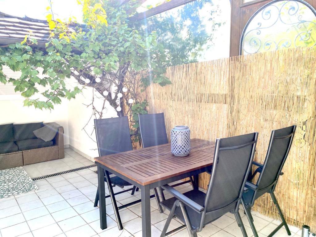 a wooden table and chairs on a patio at Apartment Bodman in Friedrichshafen in Friedrichshafen