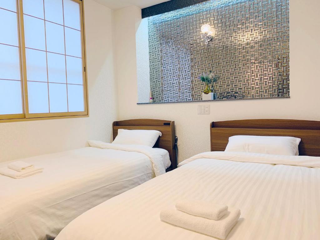 Postel nebo postele na pokoji v ubytování Allcomein Hotel Akihabara