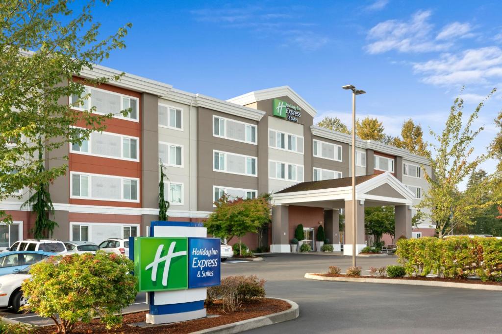 a rendering of a hotel with a sign in a parking lot at Holiday Inn Express Hotel & Suites Marysville, an IHG Hotel in Marysville
