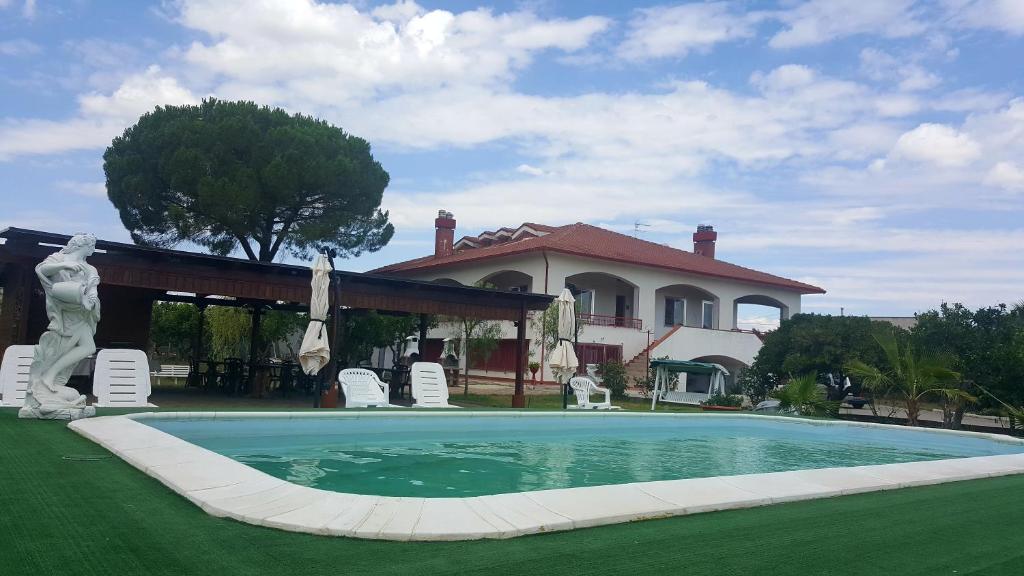 a large swimming pool in front of a house at B. & B. Villa Giada in Ginosa Marina