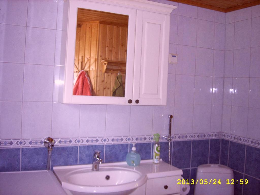 a bathroom with a sink and a white cabinet at Merimaja in Hamina