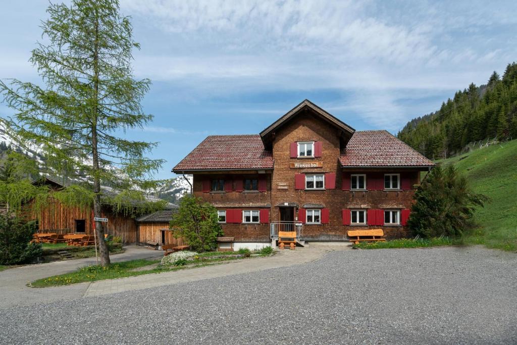 a large brick building in the middle of a road at Bergwelt-M in Schröcken