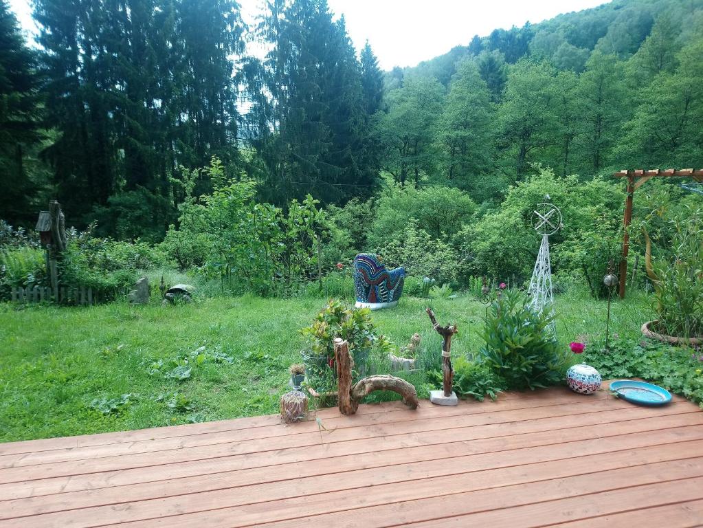 a garden with a wooden deck with plants and trees at Haus 3 Birken in Ramberg