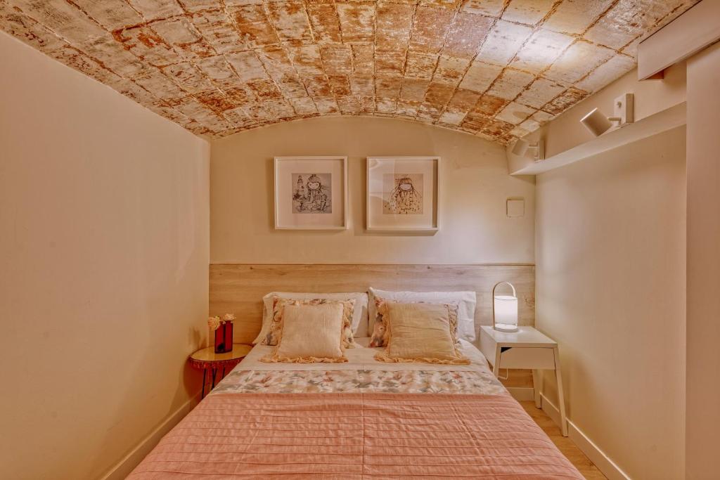 巴達洛納的住宿－Gran casa al lado de la playa y Barcelona Centro，一间卧室设有一张石质天花板床。