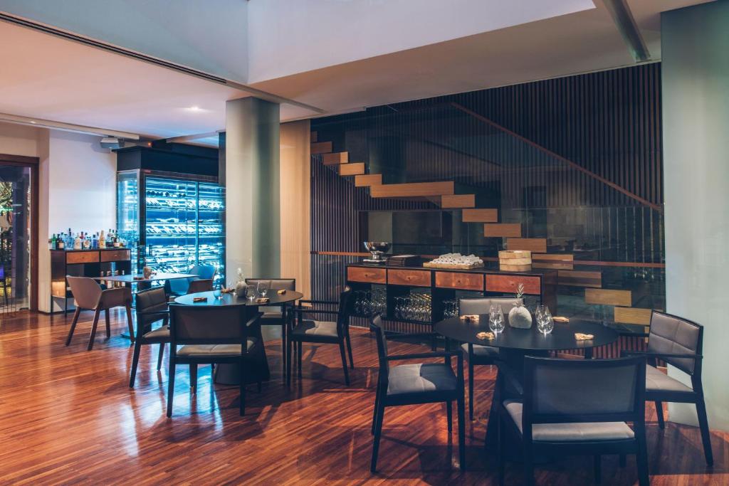 a restaurant with tables and chairs and a staircase at Iberostar Heritage Grand Mencey in Santa Cruz de Tenerife