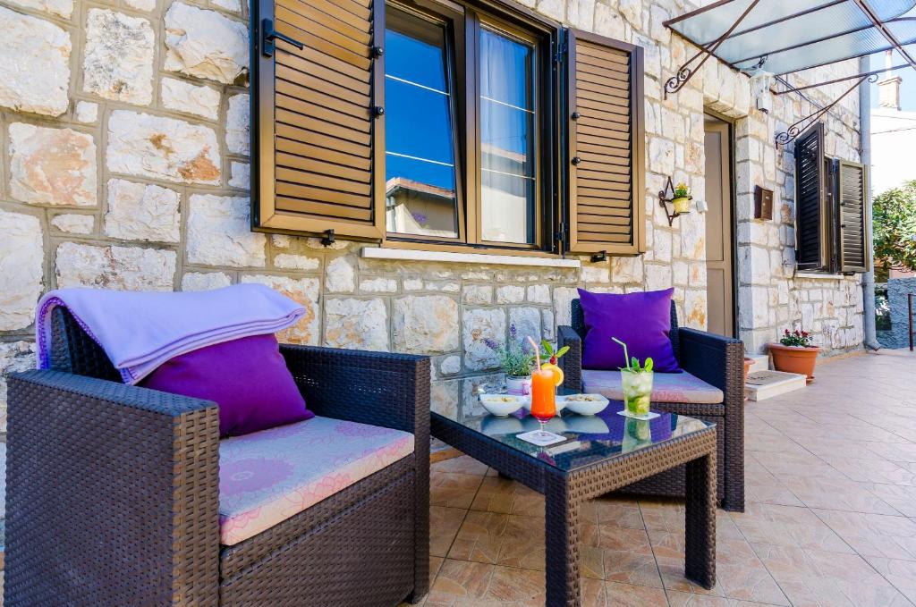 a patio with two wicker chairs and a table at Apartment Veronika in Dubrovnik