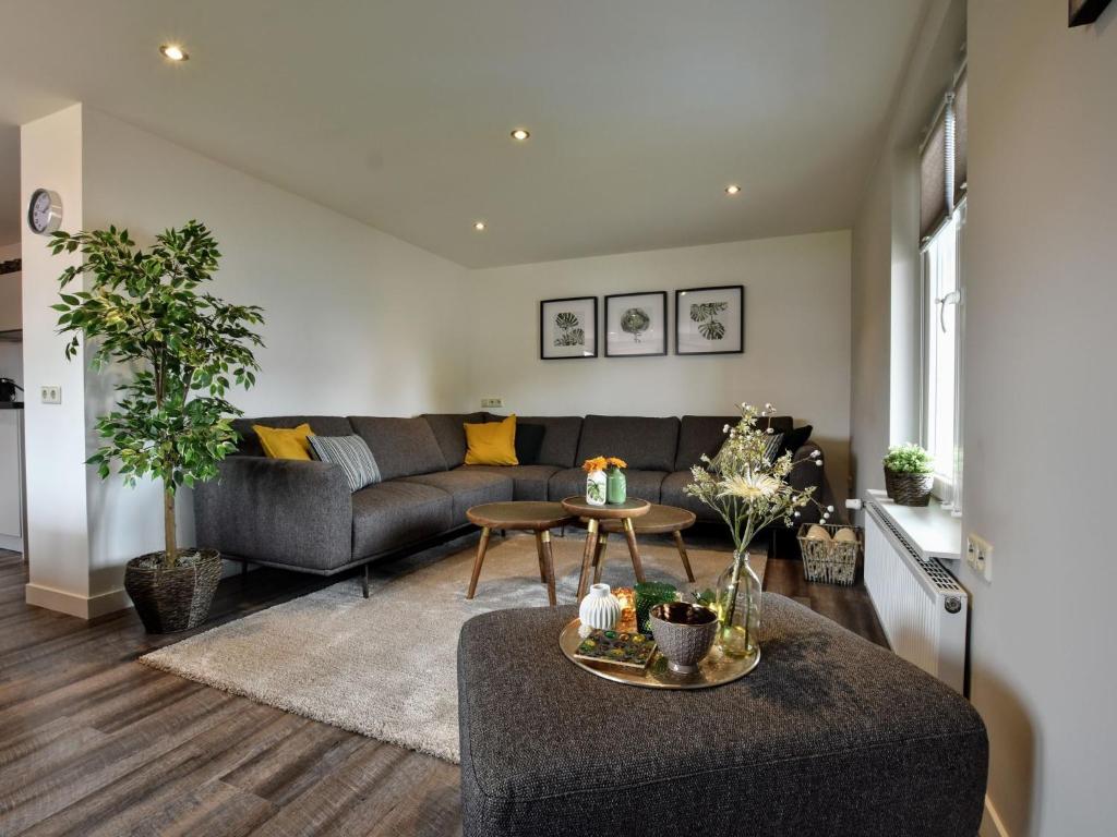 a living room with a couch and a table at Luxurious apartment in Eibergen in Eibergen