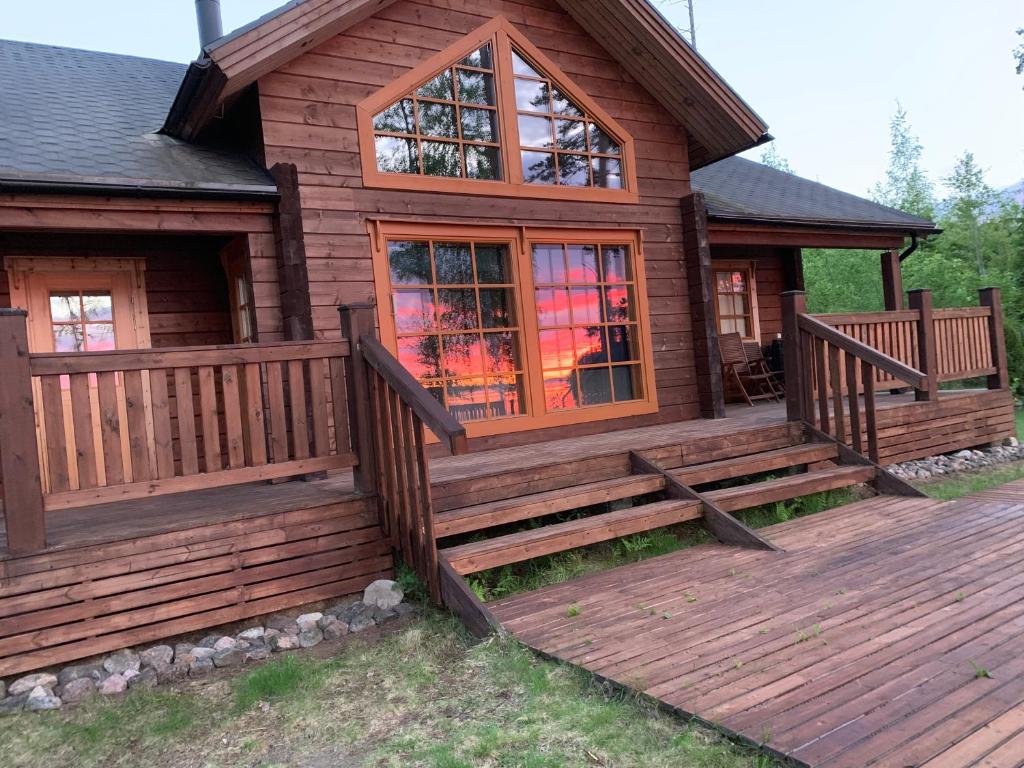 een blokhut met een veranda en een terras bij Villa Viktoriya in Arpolahti