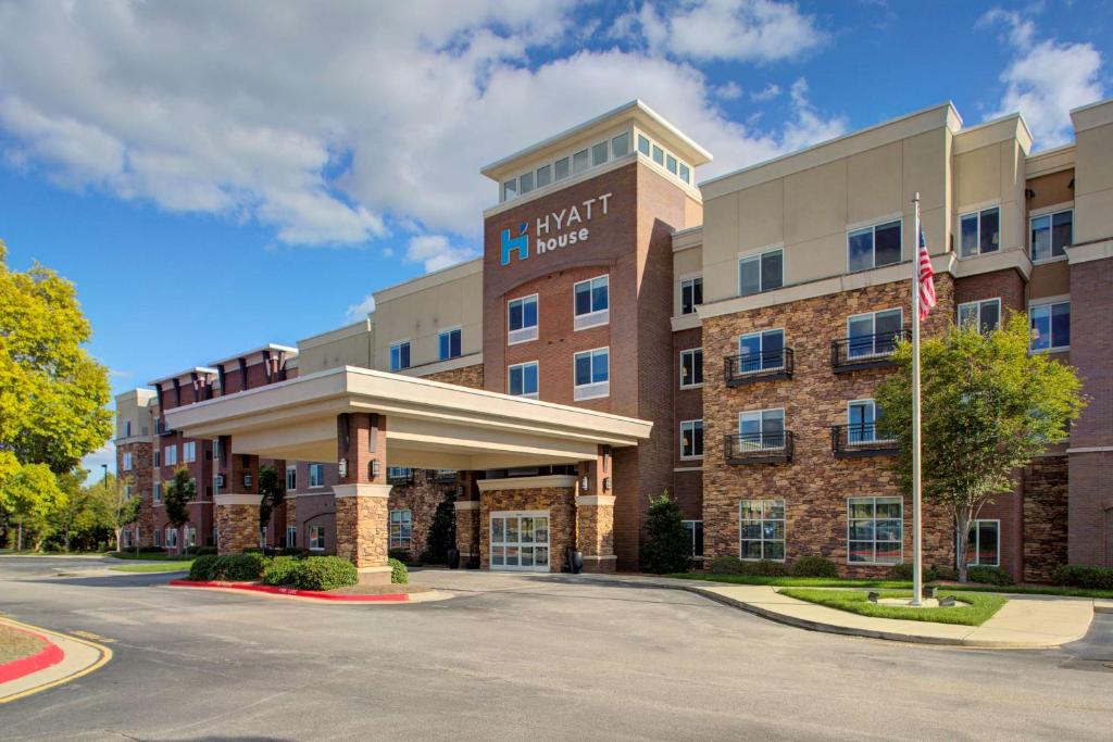 a front view of a hotel with an american flag at Hyatt House Raleigh Durham Airport in Morrisville