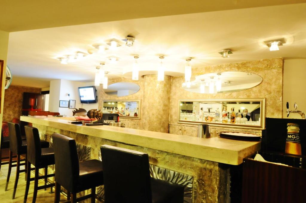 a bar in a restaurant with chairs around it at Silivri Park Hotel in Silivri