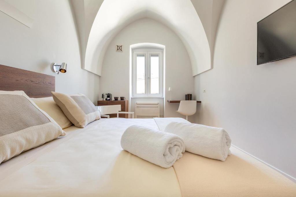 Postel nebo postele na pokoji v ubytování Palazzo Mascetti