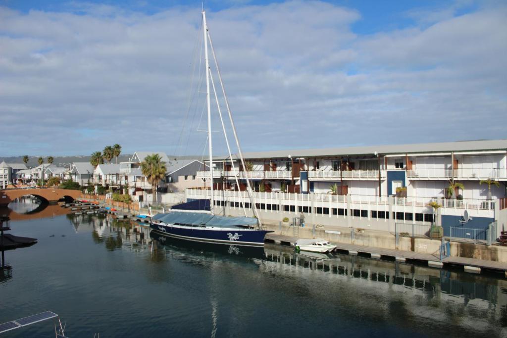 a sail boat docked at a dock in a harbor at Waterfront - Knysna Quays Accommodation in Knysna