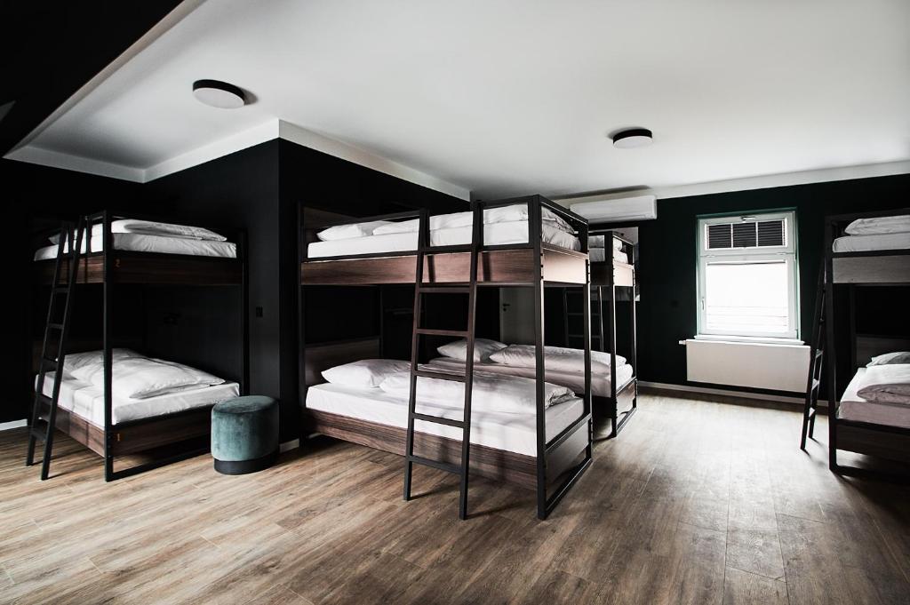 a room with four bunk beds with a window at GRONERS Leipzig City Center in Leipzig