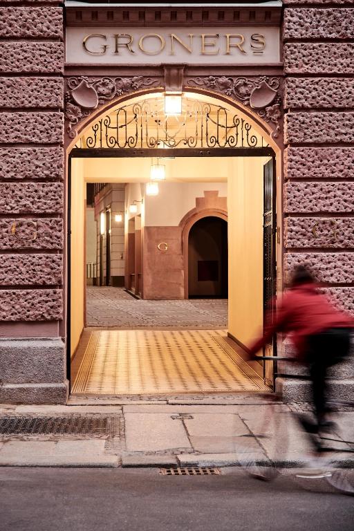 a man riding a bike in front of a store at GRONERS Leipzig City Center in Leipzig
